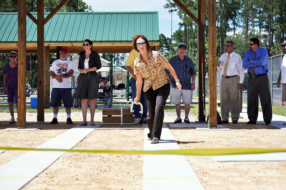 Flagler County Board of County Commissioners Chairwoman Barbara Revels pitches Monday, July 16, at the ribbon-cutting ceremony of the new courts.