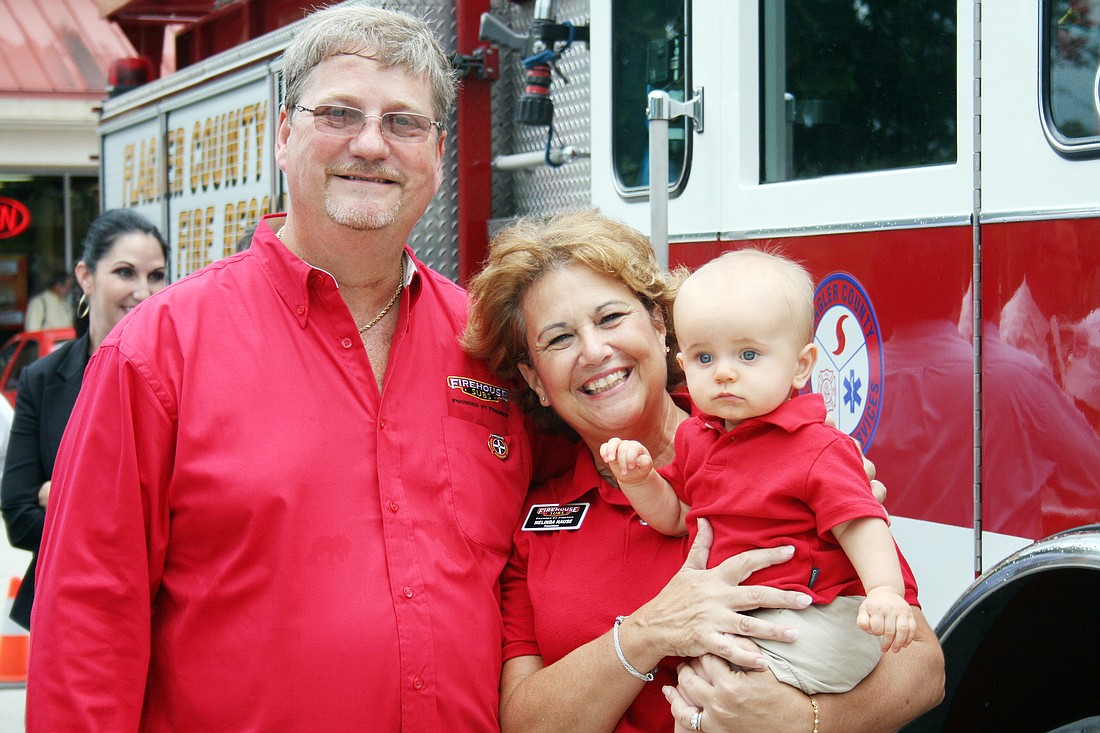 Melinda and David Hause, holding grandson Landon Ecklof, also own Firehouse Subs franchises in Ormond Beach, South Daytona and on International Speedway Boulevard. PHOTOS BY MIKE CAVALIERE