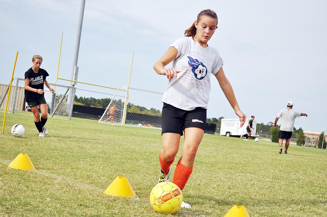 Kerry Norberg weaves through cones while working on her dribbling Tuesday, July 31.