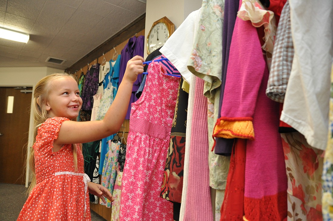 Millie Boyd, 6, has helped her mother, Heide with organizing the dresses that have been donated.