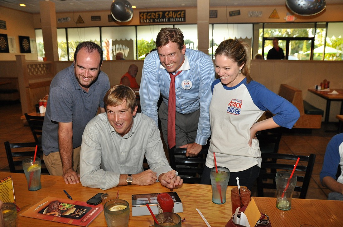 Bill MacQueen, Bob Atack, Craig Atack and Michelle Montano watch as results are loaded Tuesday night. Craig Atack will face Melissa Moore Stens in November.