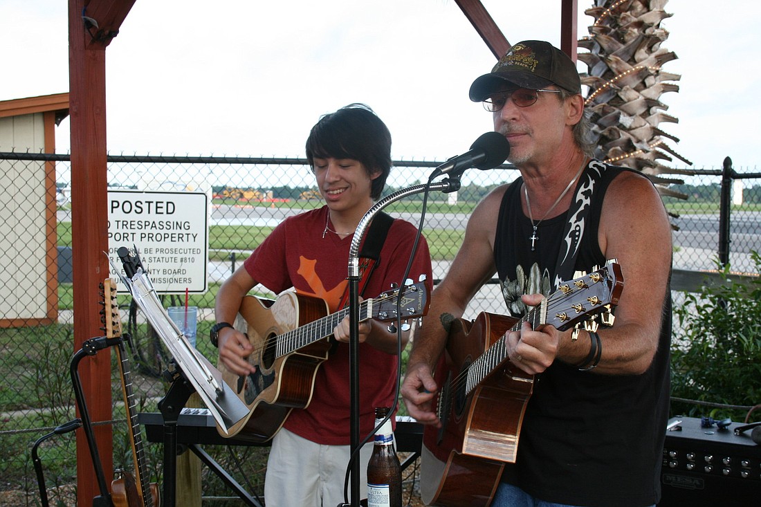 Michael Ricker plays with his father, Joe Ricker, at the High Jacker Restaurant.