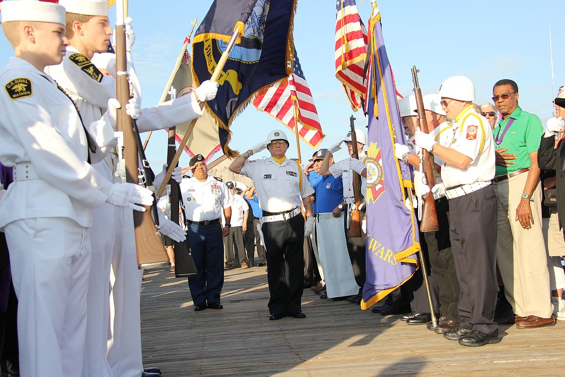 Nemo Farmer, of the Palm Coast VFW, stands at salute, Tuesday, Sept. 11, at the Flagler Beach Pier.