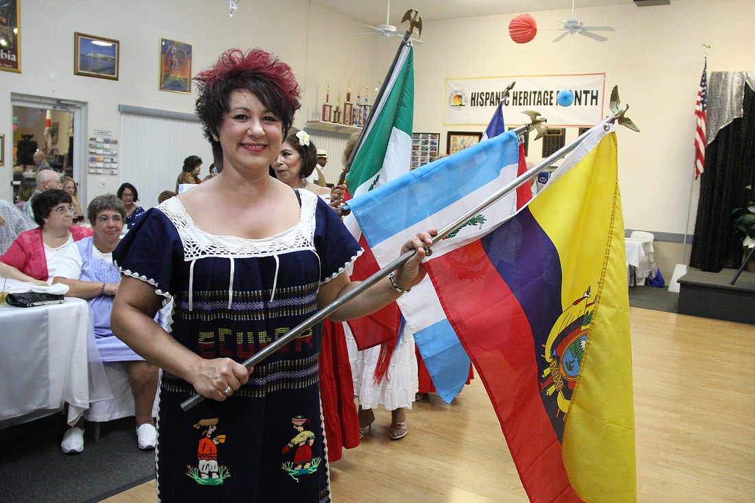 Michele Herdoiza represents Ecuador during the parade of flags Saturday, Sept. 15, at the event.