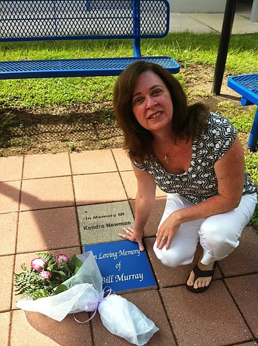 Dee Murray places flowers on the tile dedicated to her late husband, Bill.