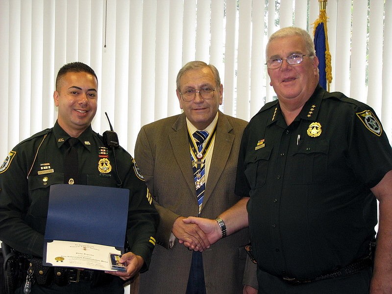 Sgt. Phillip Reynolds, SAR Chapter President Ted St. Pierre and Flagler County Sheriff Don Fleming