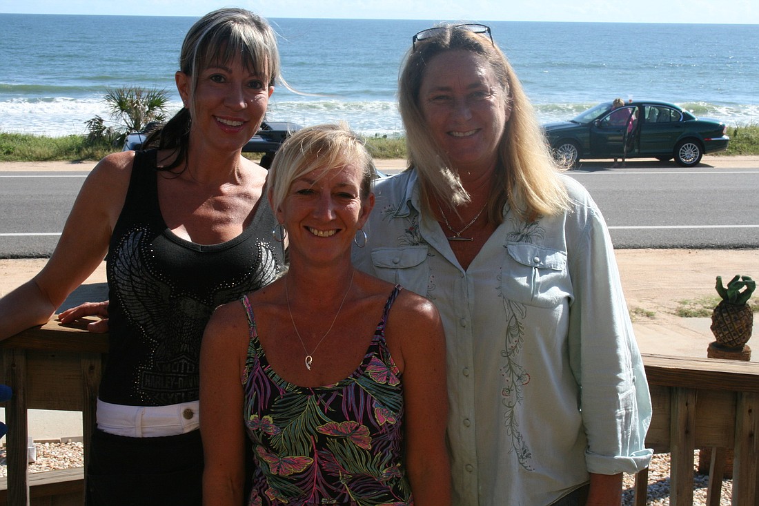 Lisa Scartelli and Jenny Watkins, both servers, join one of the restaurant's owners, Danita Mundy, on Java Joint's deck.