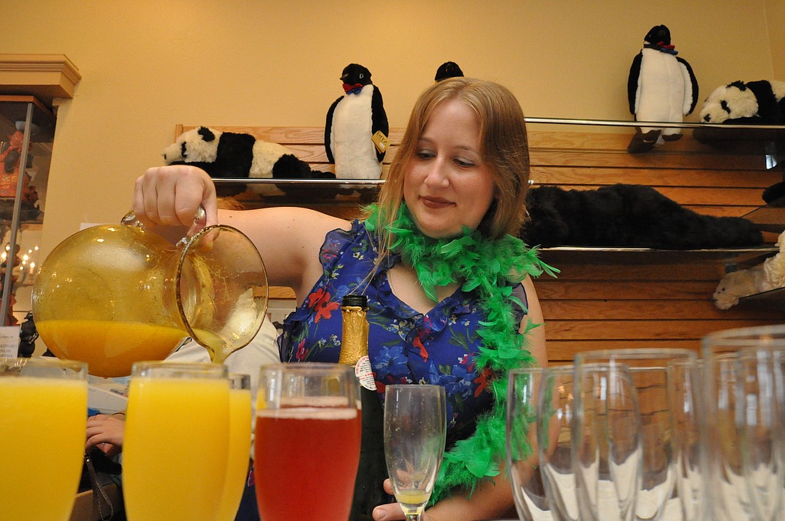 Kelly Buck, a Flagler Humane Society volunteer, prepares mimosas at the midday event.