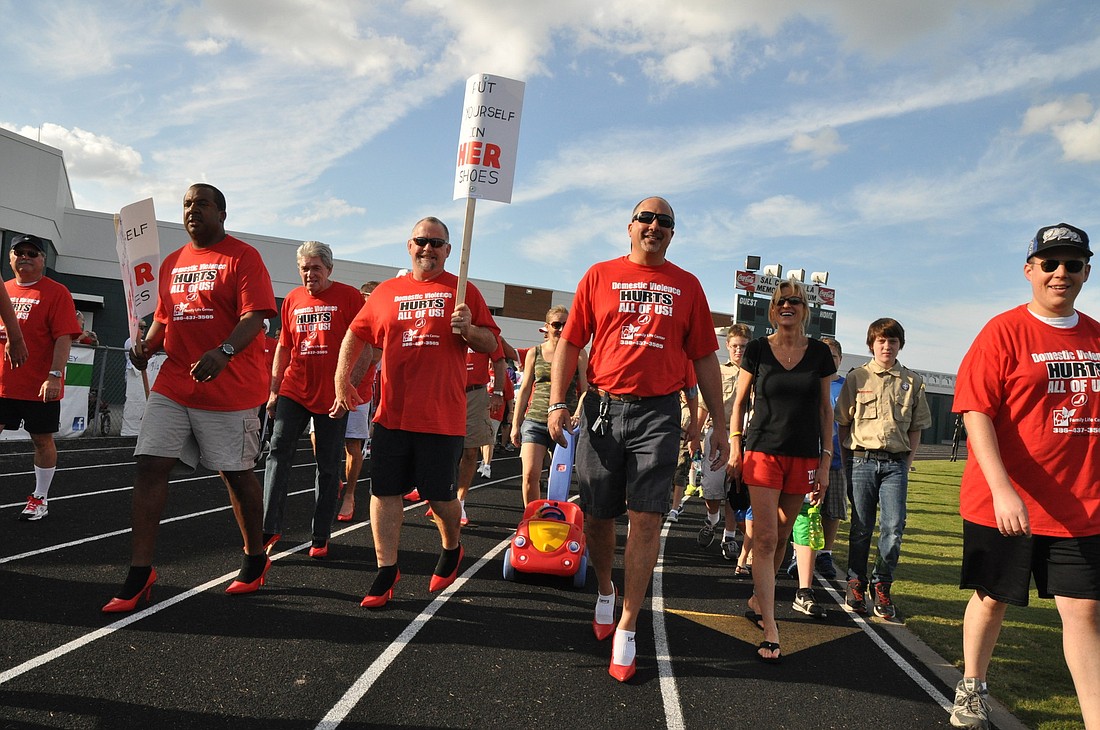 Men sported high heels Saturday, Oct. 13, as they walked a mile on the Flagler Palm Coast High School track in support of domestic violence awareness.