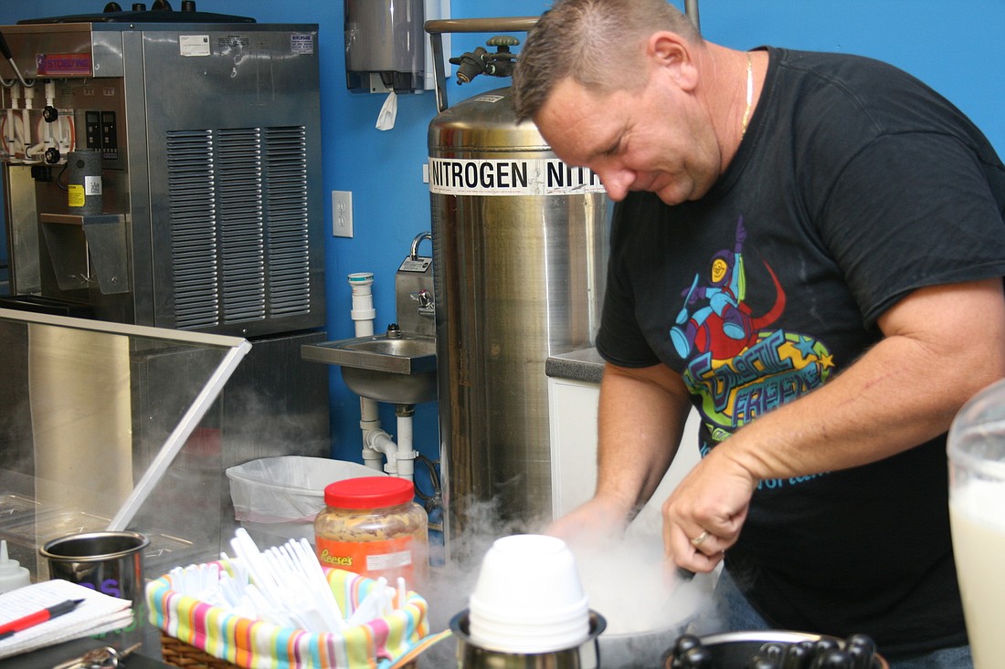 Donald Stevens watches the smoke die down as he makes a bowl of ice cream using liquid nitrogen.
