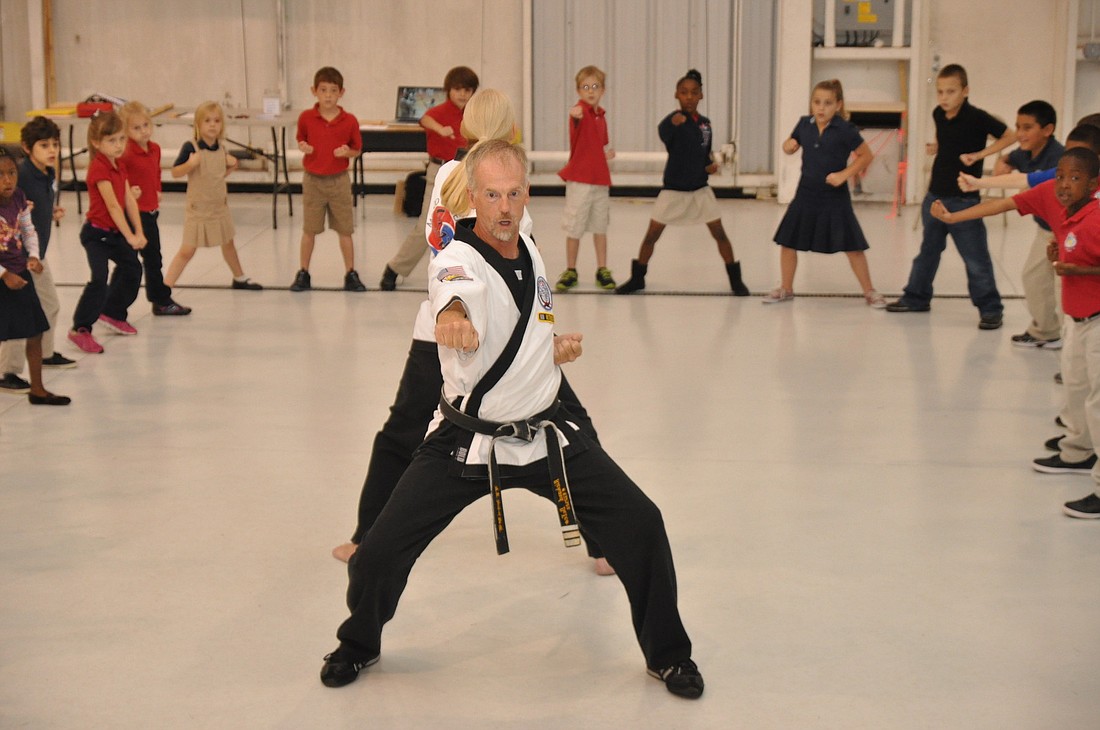 Rich Defeo, of Moo Doo Academy, shows kindergarten through third drade students basics karate moved during his presentation.