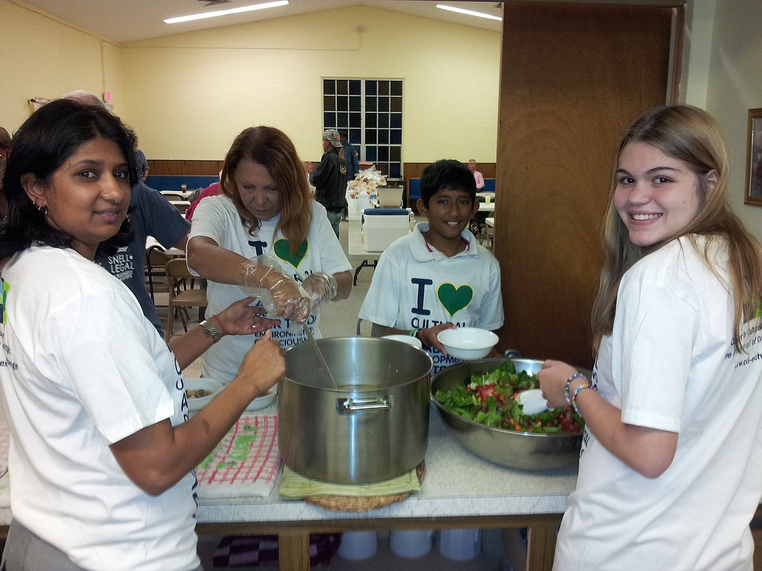 Pattie Toolsie, Nina Pope, Nick Toolsie and Bia Nasorri prepare food to serve at The Sheltering Tree, in Bunnell. Nasorri is an exchange student from Brazil.
