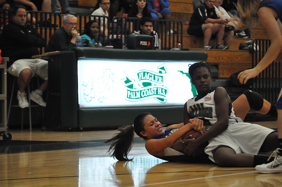 Flagler Palm Coast point guard Armani Walker (right) attempts to steal the ball Saturday night. FPC won the game, 54-36, to improve to 5-1 this season.