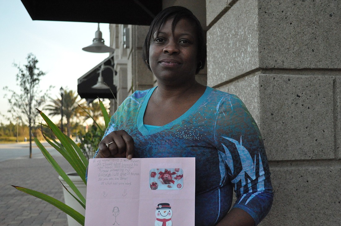 Susan Crockett with the card that was left in her mailbox by a 9-year-old Palm Coast resident. ANDREW O'BRIEN