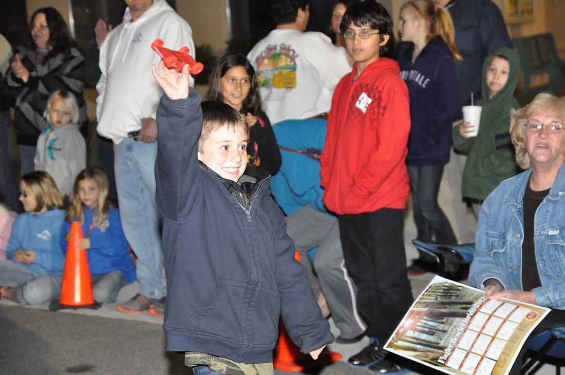 Austin McKay celebrates after winning the kids division of the Pinewood Derby with his car Red Rumble.