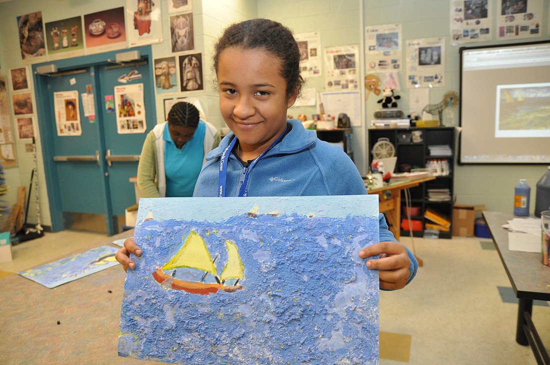 Devyn Adama shows off her finished piece.