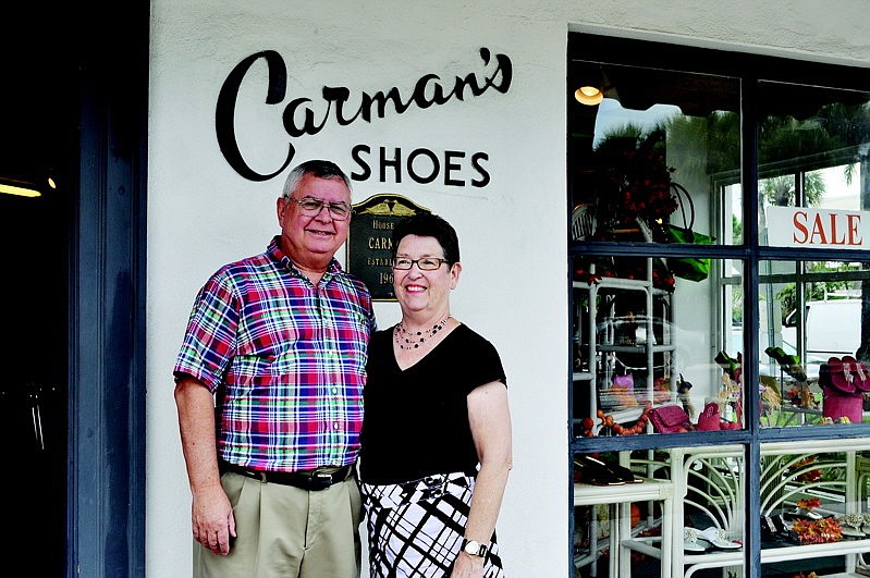 Owners Bill and Judy Carman stand in front of the three-story CarmanÃ¢â‚¬â„¢s Shoes & Handbags store on St. Armands Circle.