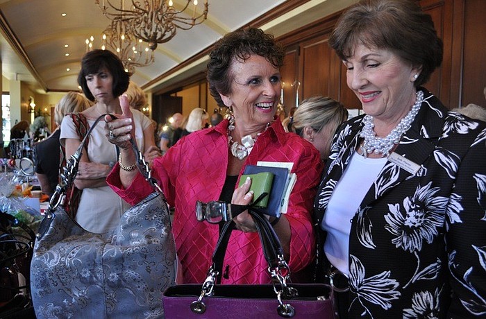 Nancy Phillips and Beth Pheney of Michael Saunders checked out some purses and other items.
