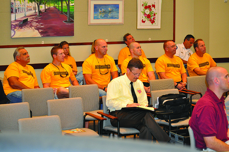 Longboat Key firefighters wore matching yellow T-shirts as they sat in the back of the Town Hall Chambers listening to attorneys present their case during a contract impasse hearing Thursday, Sept. 16.