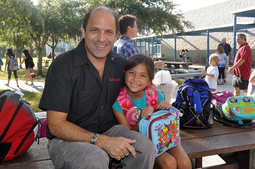 Ron and Sofia Genta chat for a few minutes on a picnic table after breakfast.