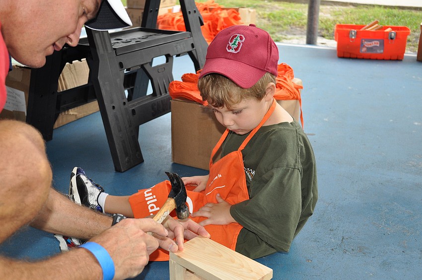 Alan Dorrill helps his son, Samuel, with his Home Depot project