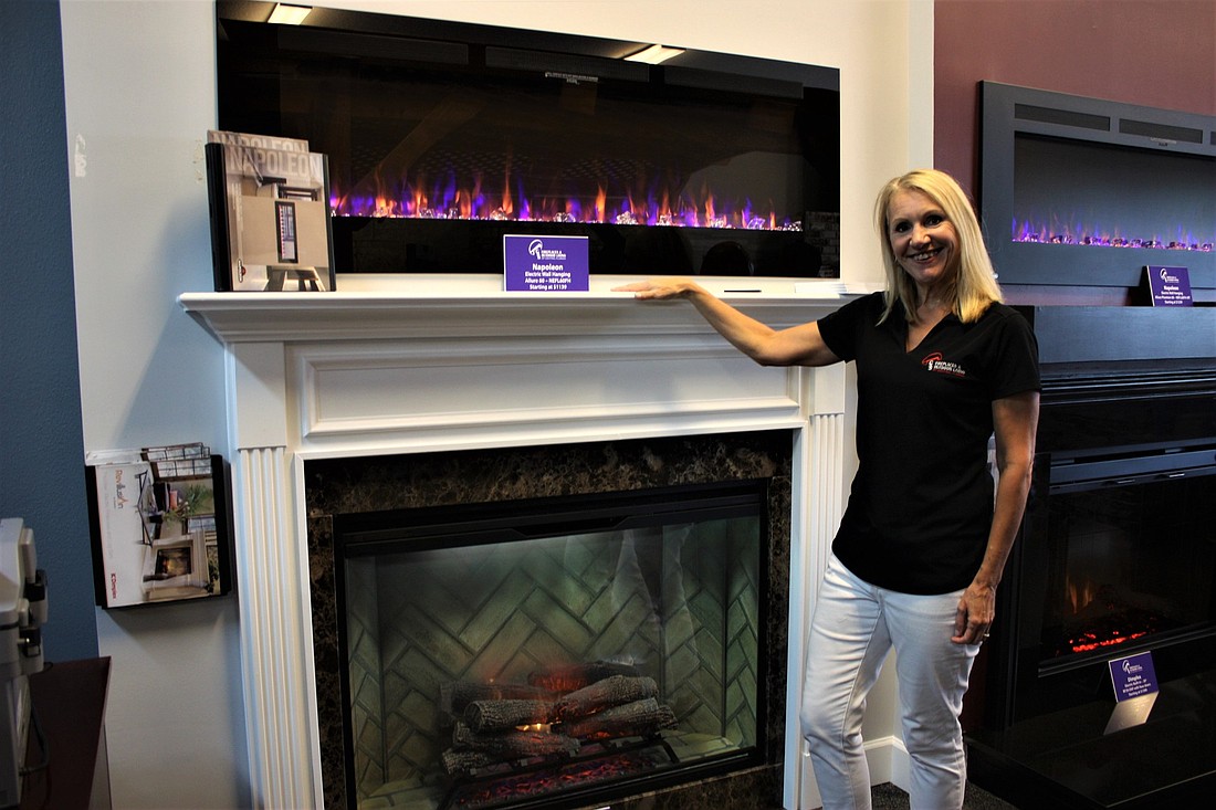 Kathy Shaffer, of CSS Fireplaces and Outdoor Living, shows the traditional and modern styles of fireplaces. Photo by Wayne Grant