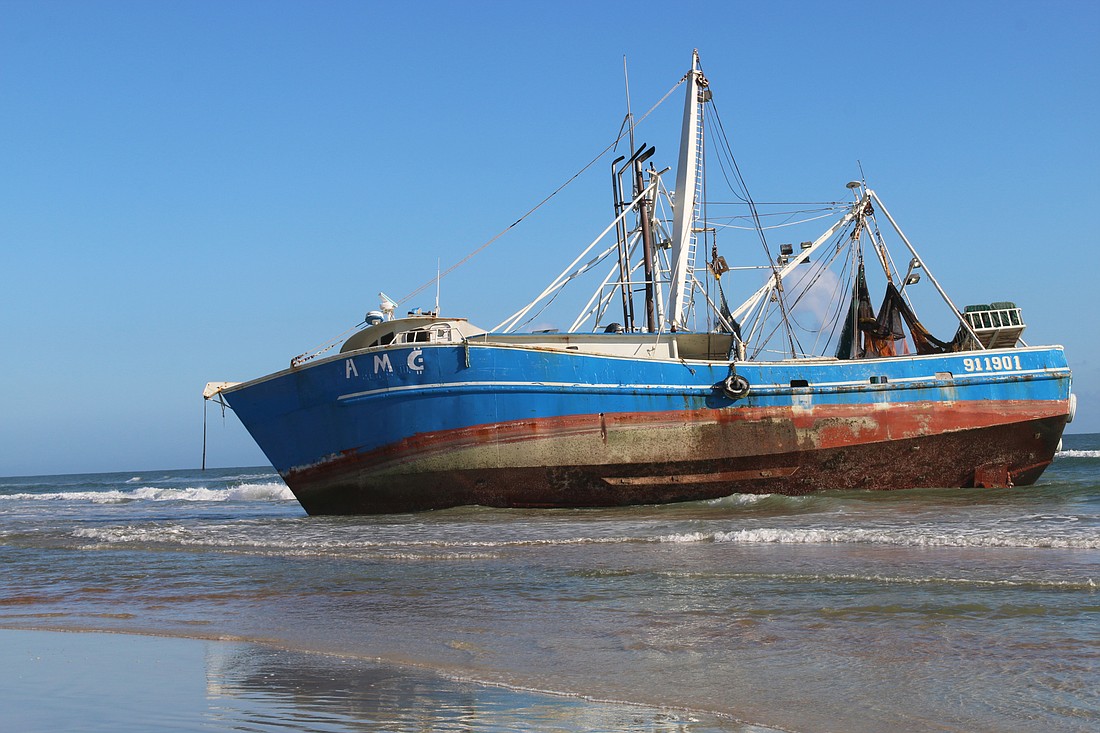 The 77-foot AMG fishing vessel washed ashore near the Cardinal Drive beach approach in Ormond Beach on Tuesday, Oct. 16. Photo by Jarleene Almenas