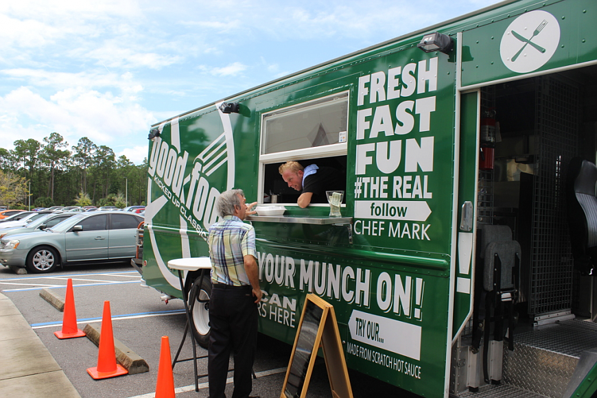 Ormond Beach resident and Executive Chef Mark Pullin serves meals from his food truck in 2015. File photo by Emily Blackwood