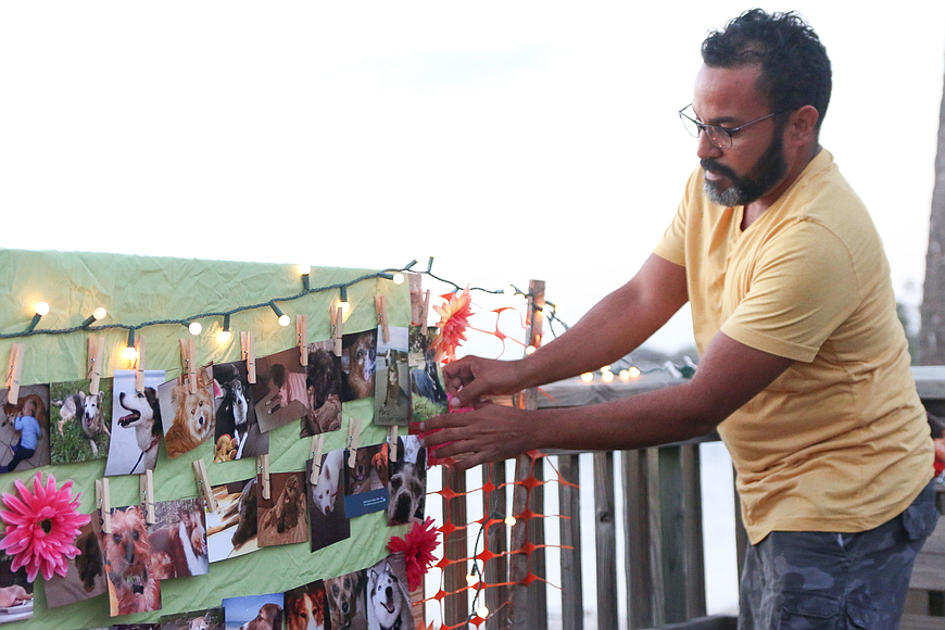  Casselberry resident Alex Martinez hangs up photos of dogs he lost, Paris and Oynx, at the fourth-annual Rainbow Bridge Walk. File photo by Paige Wilson