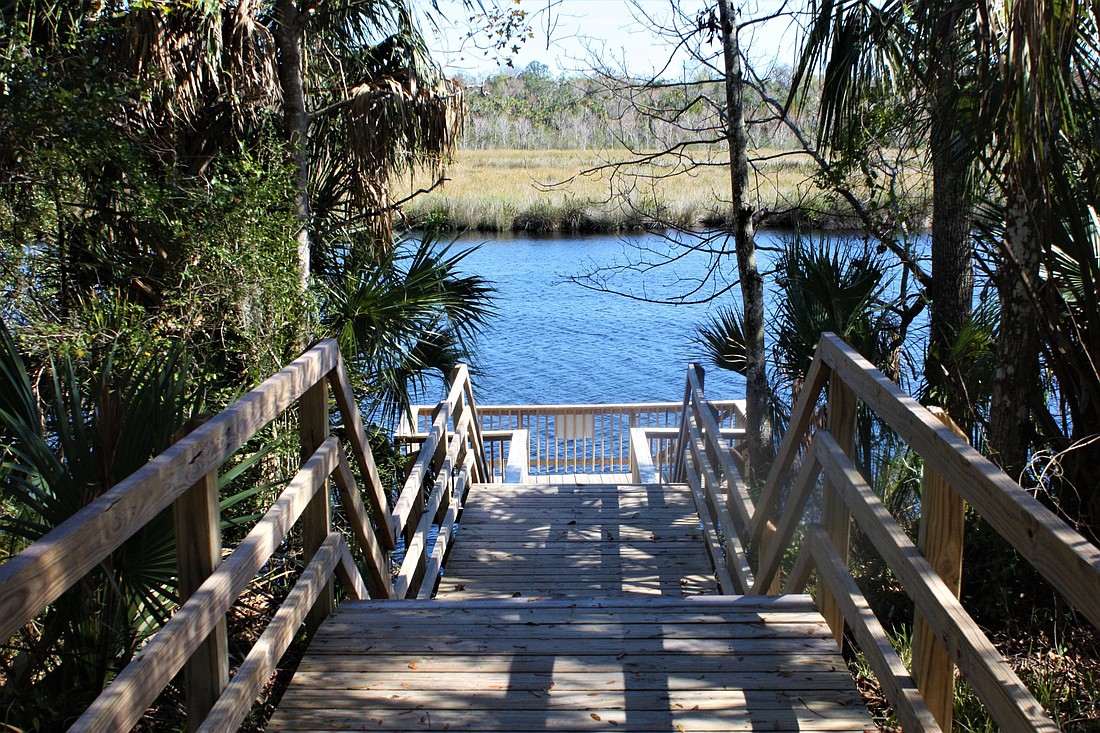 A walkway leads to a fishing/viewing dock on the Tomoka River at Riverbend Nature Park. Photo by Wayne Grant