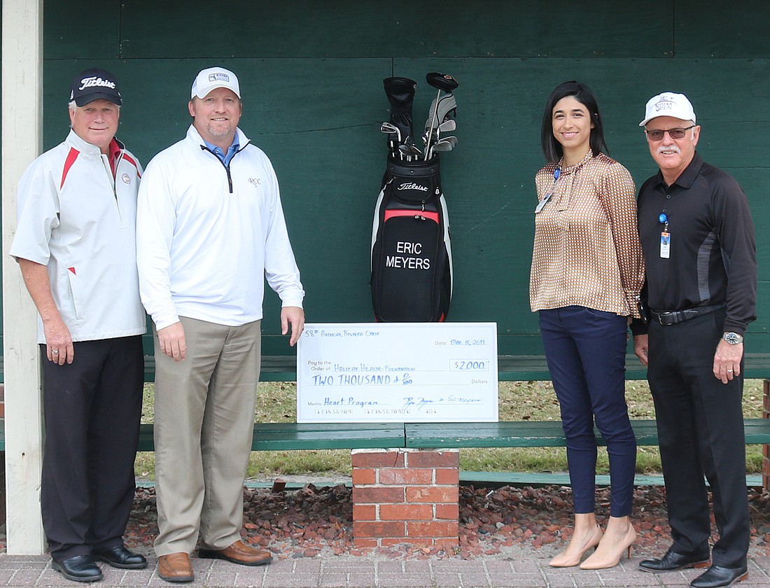 Eric Meyers; Ryan Meyers; Halifax Health-Foundation Development Manager Kathryn Nagib; and Foundation Executive Director Joe Petrock are shown with a check from Annual Riviera Open pro-am golf tournament. Courtesy photo