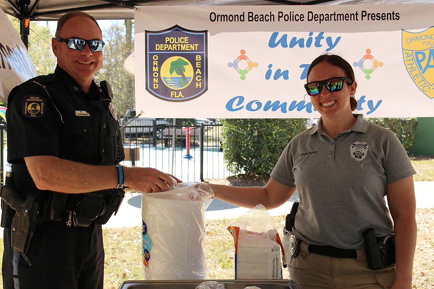 Officer Bobbie Pearson and Officer Marianne Durkin enjoy some shade at the previous Unity in the Community event at the South Ormond Neighborhood Center on Saturday, March 17, 2018. File photo by Jarleene Almenas