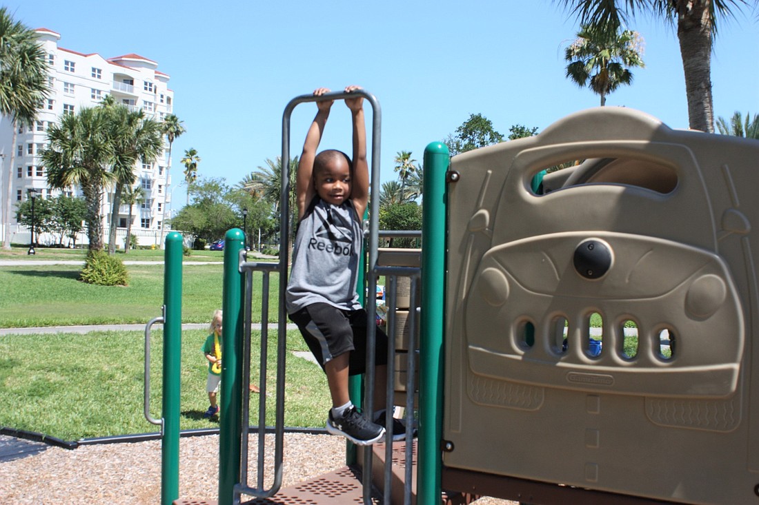 Jordan Holloway, visiting from Philadelphia, enjoys the playground at Fortunato Park. The Downtown Steering Committee has suggested the city offer more activities at all four corners of Granada Bridge. Photo by Wayne Grant