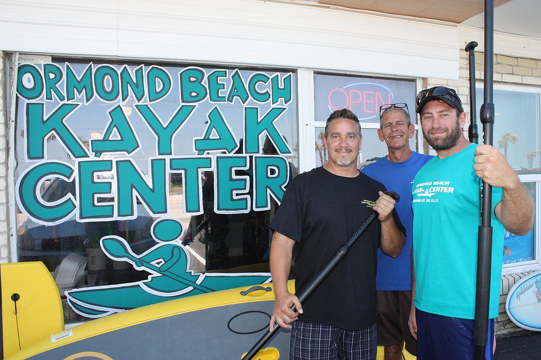 Mark Pritchard, Bill Muller and Paul Murphy celebrate the grand opening of Ormond Beach Kayak Center. Photo by Wayne Grant