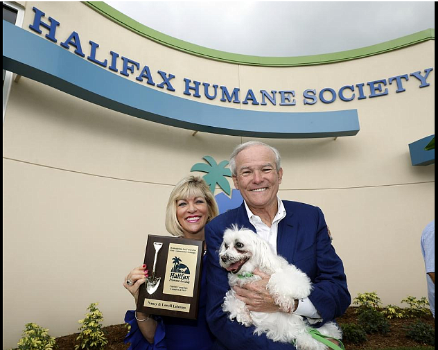Nancy and Lowell Lohman are shown with Snowball at the grand opening of the Halifax Humane Society after a major renovation. Courtesy photo by Humane Society