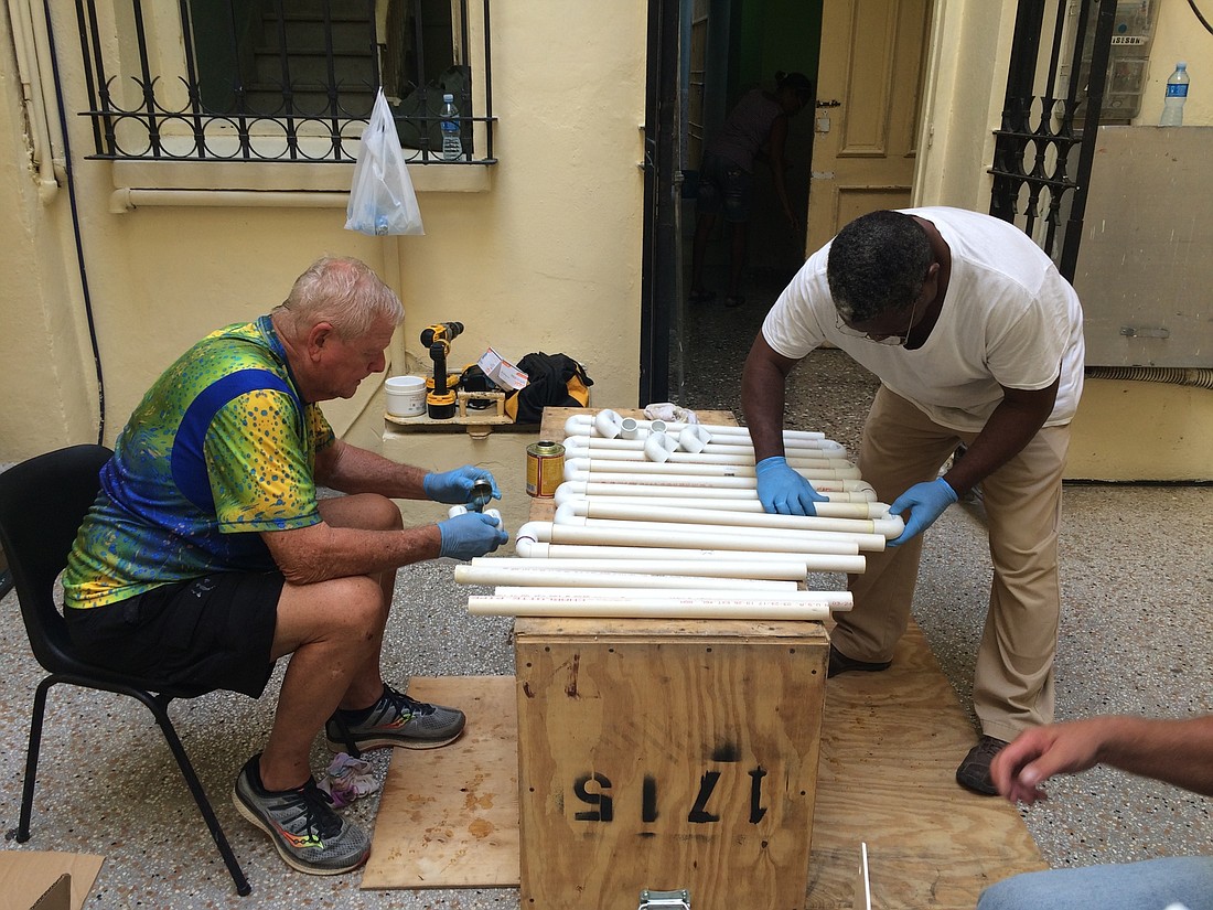 Jerry Penny, of Port Orange, helps put a clean water system together in Cuba. Courtesy photo
