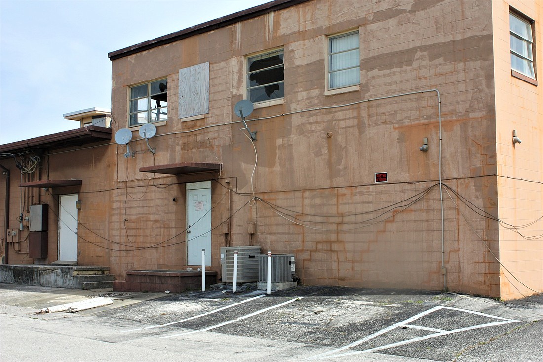 Broken windows in the former Julian's restaurant, set to be demolished, allow the elements to enter. File photo
