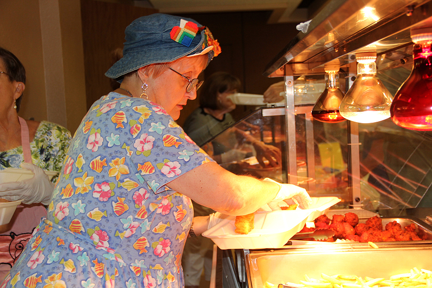 Joy Fluner was one of a team of church volunteers who served guests at St. James Episcopal Church's annual fish fry in 2017. File photo by Jacque Estes