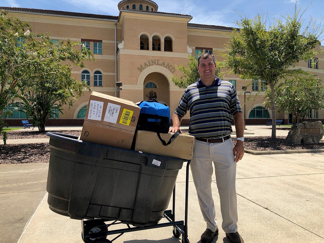 AdventHealth donated over $8,000 of equipment to help prevent and treat heat-related illnesses for Volusia County student athletes. Shown is Mainland High School Athletic Director Pat Monohan. Courtesy photos