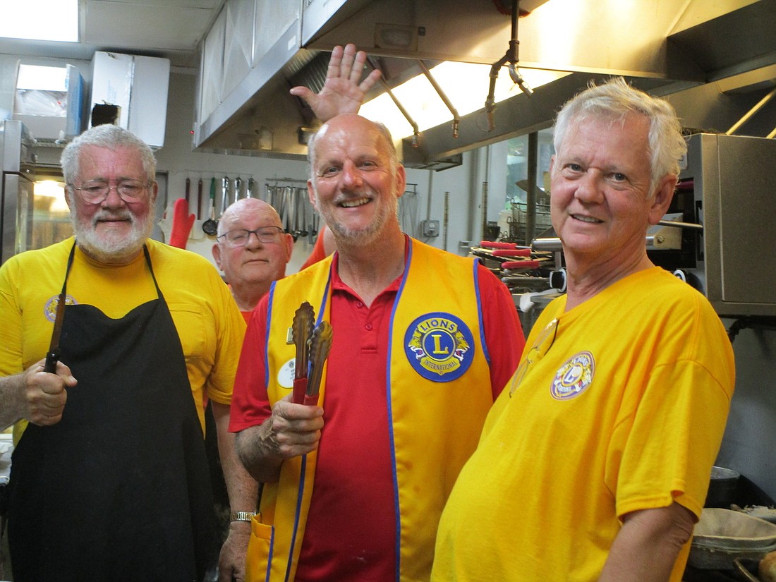 Lions Past President Les Walter, Frank White, District Governor Lion Greg Evans and Lion Jack McGurk cooked some fish for the club's annual fish dinner fundraiser. Courtesy photo