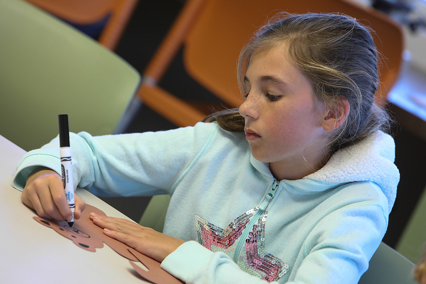 Sylvia Richards, 10, of Ormond Beach, crafts during the Elementary Explorers program at the Environmental Discovery Center on Saturday, Jan. 5. Photo by Anthony Boccio
