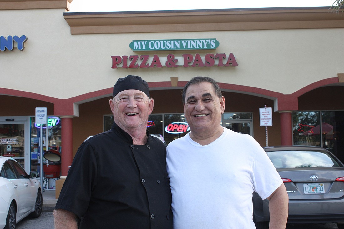 Jerry Bush, chef, and Mario Younes, owner, pose in front of My Cousin Vinny's Italian Restaurant. Photo by Wayne Grant