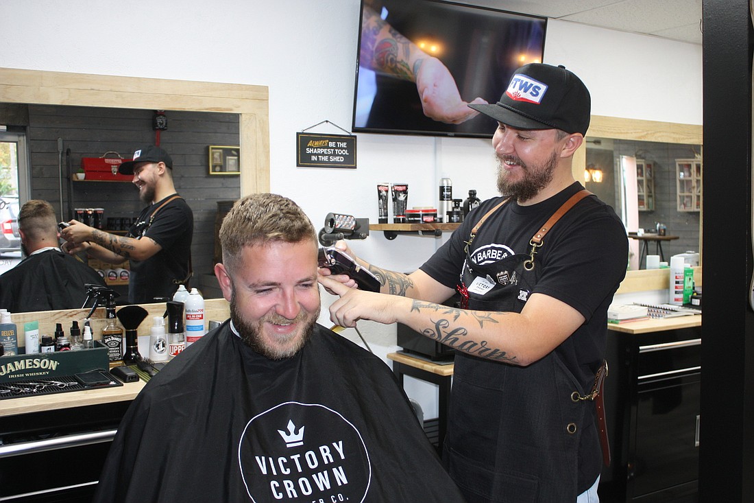 Bandon Castaldi cuts the hair of customer Seth Mallory at his new shop, Proper Barber Co. Photo by Wayne Grant