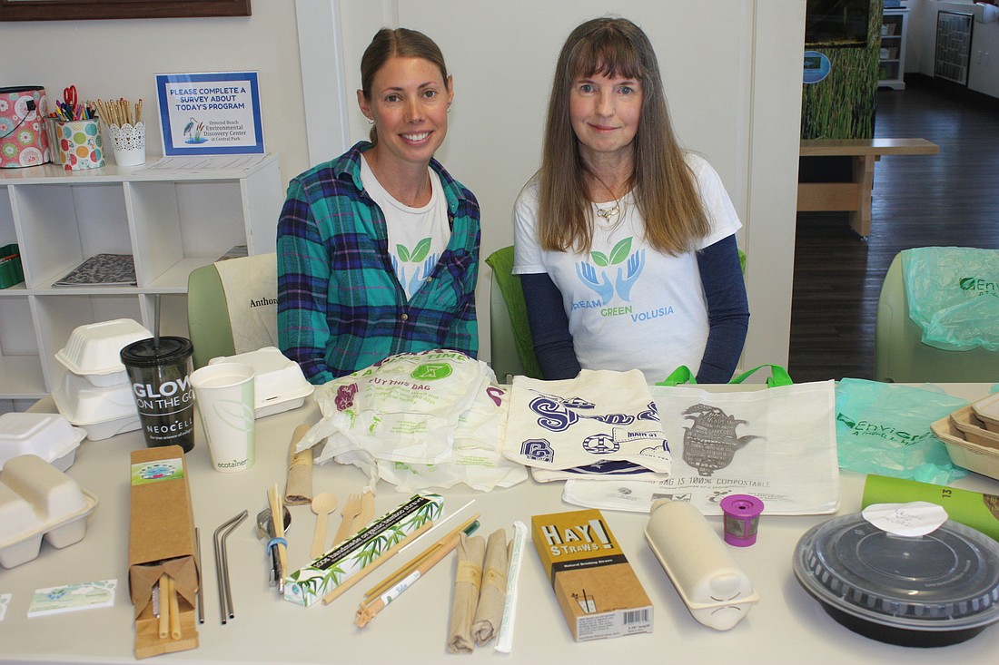 Becca Chaffee and Suzanne Scheiber, of Dream Green Volusia, show items that can be used instead of single-use plastics. Photo by Wayne Grant