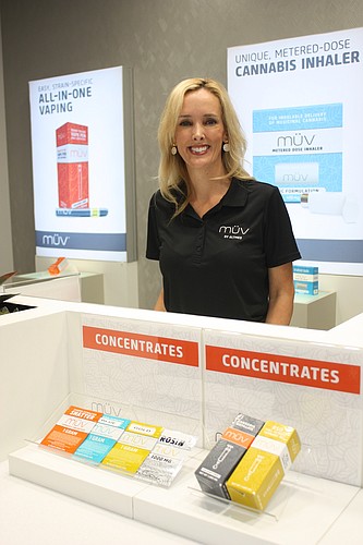 Kate Palazzolo explains the various medical marijuana products available at the newly opened MÃœV Dispensary. Photo by Wayne Grant