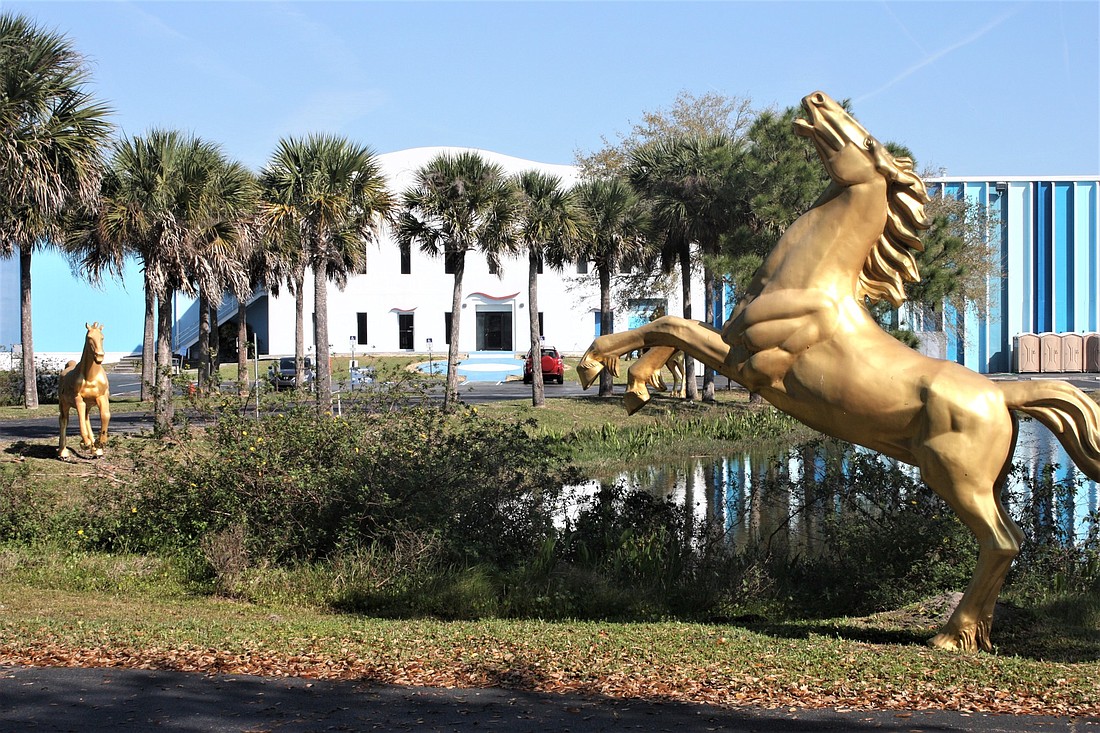 The retention pond in front of the building at 1899 N. U.S. 1 is surrounded by statues of galloping horses, installed by a previous owner. Photo by Wayne Grant