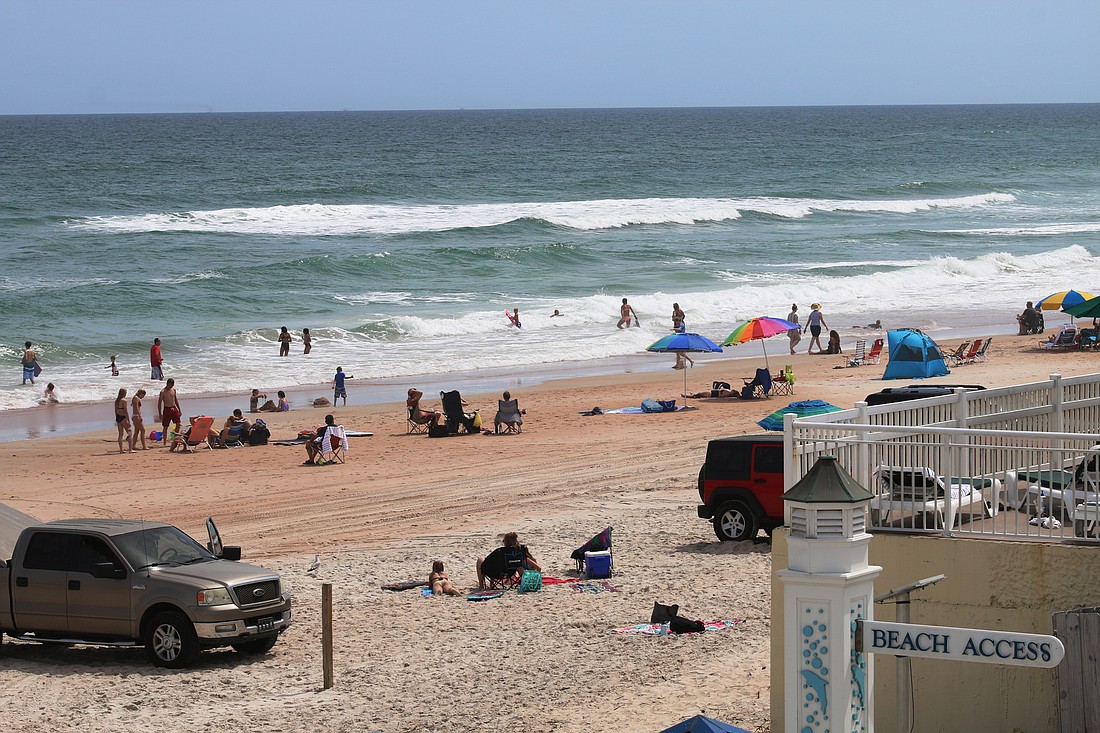 Beachgoers enjoy a day at the Granada beach approach despite rising number of COVID-19 cases in Florida. There are 9 cases in Volusia County. Photo by Jarleene Almenas