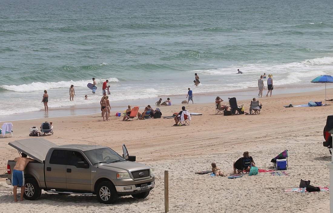 Beachgoers enjoy a day at the Granada beach approach last week. File photo by Jarleene Almenas