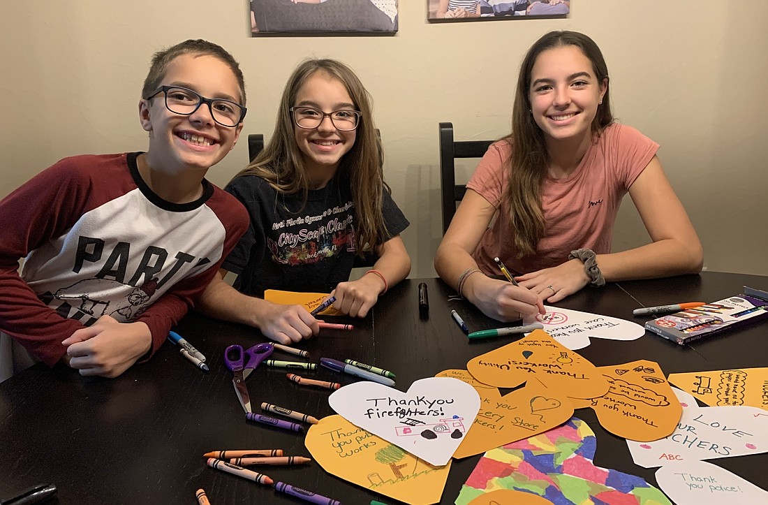 Owen, Taylor and Brooke Elston craft hearts for first responders and healthcare workers. Courtesy photo