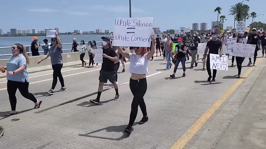 A screenshot of the video shared by VCSO on Facebook showing Daytona Beach protestors marching with signs. Courtesy of VCSO